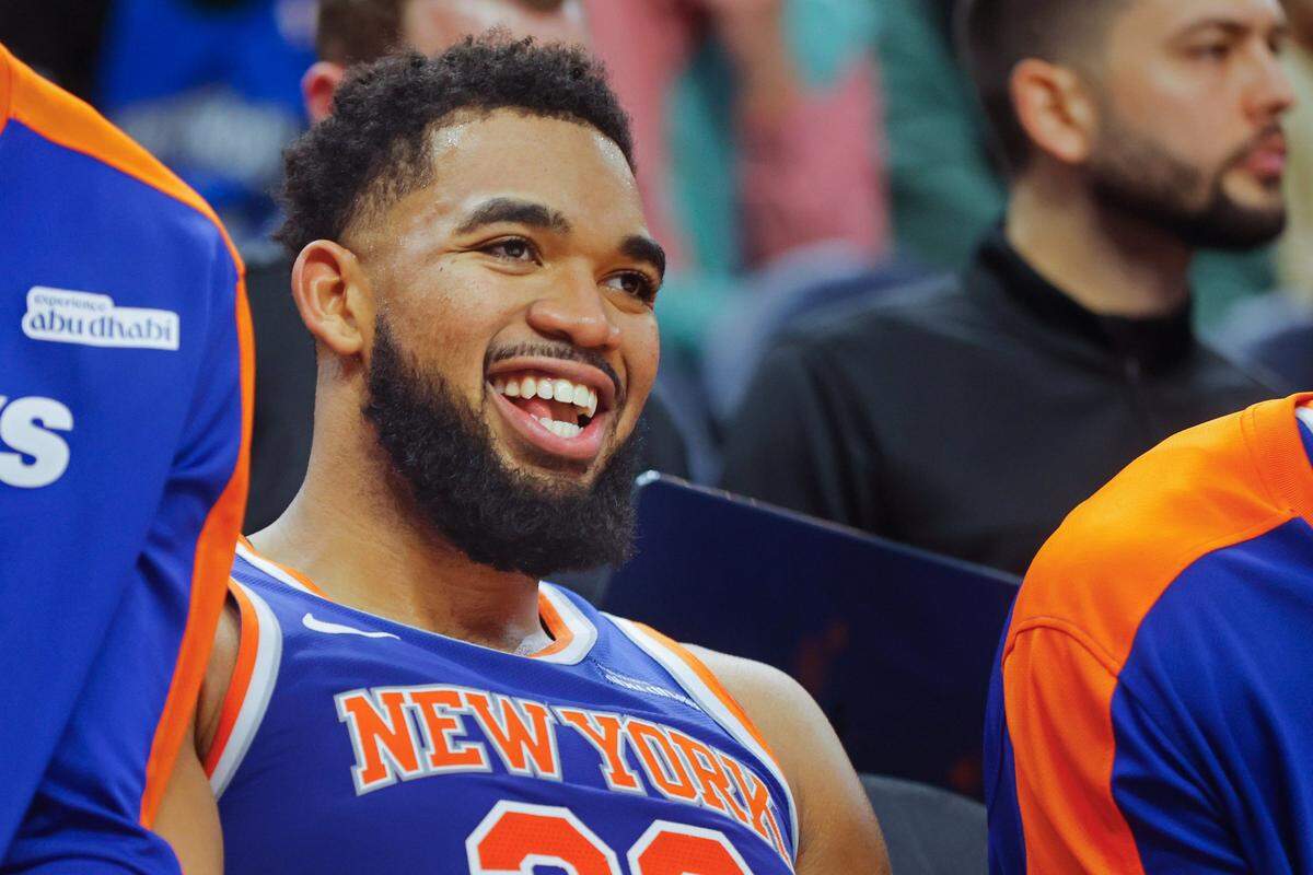 Dec 19, 2024; Minneapolis, Minnesota, USA; New York Knicks forward Karl-Anthony Towns (32) smiles as he rests on the bench in the fourth quarter of the game with the Minnesota Timberwolves at Target Center. Mandatory Credit: Bruce Kluckhohn-Imagn Images