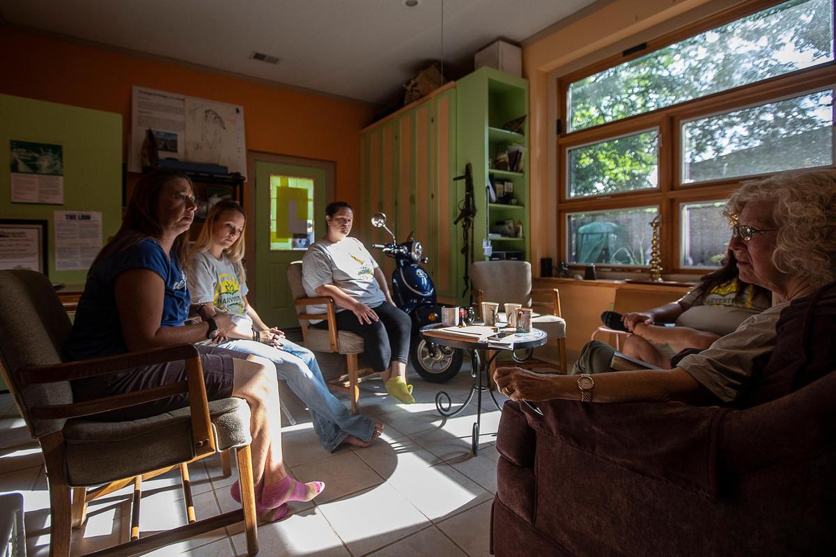 Rhonda Yarnell, from left, Teresa Kronmueller and Lindsay Gay, all graduates of Harvesting Hope, talk with program executive director Cheyenne Olson at the Berea Urban Farm in Berea on Aug. 22.