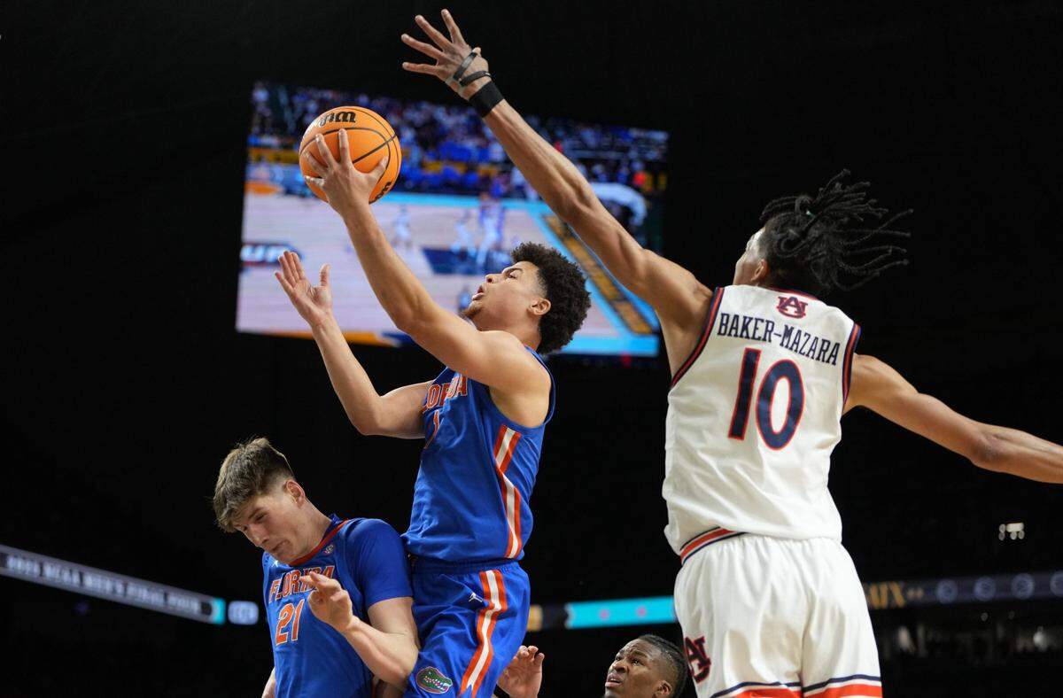 Florida guard Walter Clayton Jr. (1) shoots the ball against Auburn guard Chad Baker-Mazara (10) during the second half in the NCAA semifinals at the Alamodome in San Antonio on Saturday.