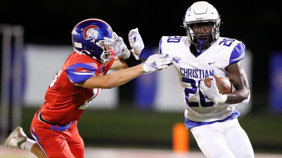 Lexington Christian’s Xavier Brown (20) runs the ball past Christian Academy-Louisville’s Isaac Patrick (15) during a game at Christian Academy-Louisville in Louisville, Ky., Friday, Sept. 10, 2021. Lexington Christian beat Christian Academy-Louisville 37-14.