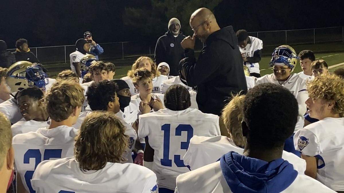 Henry Clay head coach Demetrius Gay wipes away a tear as he addresses his team following the Blue Devils’ 21-6 victory over Paul Laurence Dunbar on Friday night. The win ended the school’s 22-game football losing streak.