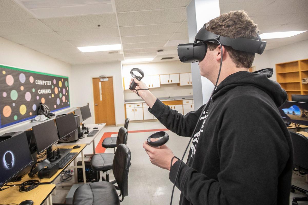 Brady Adams, a junior at Perry County Central High School, uses one of the school’s new virtual reality consoles Wednesday, Dec. 4, 2019 in Hazard, Ky.
