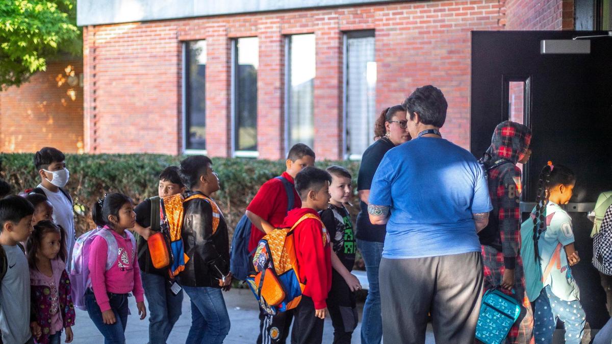 Students arrive for the first day of school at Northern Elementary School in Lexington, Ky., on Wednesday, Aug. 16, 2023.