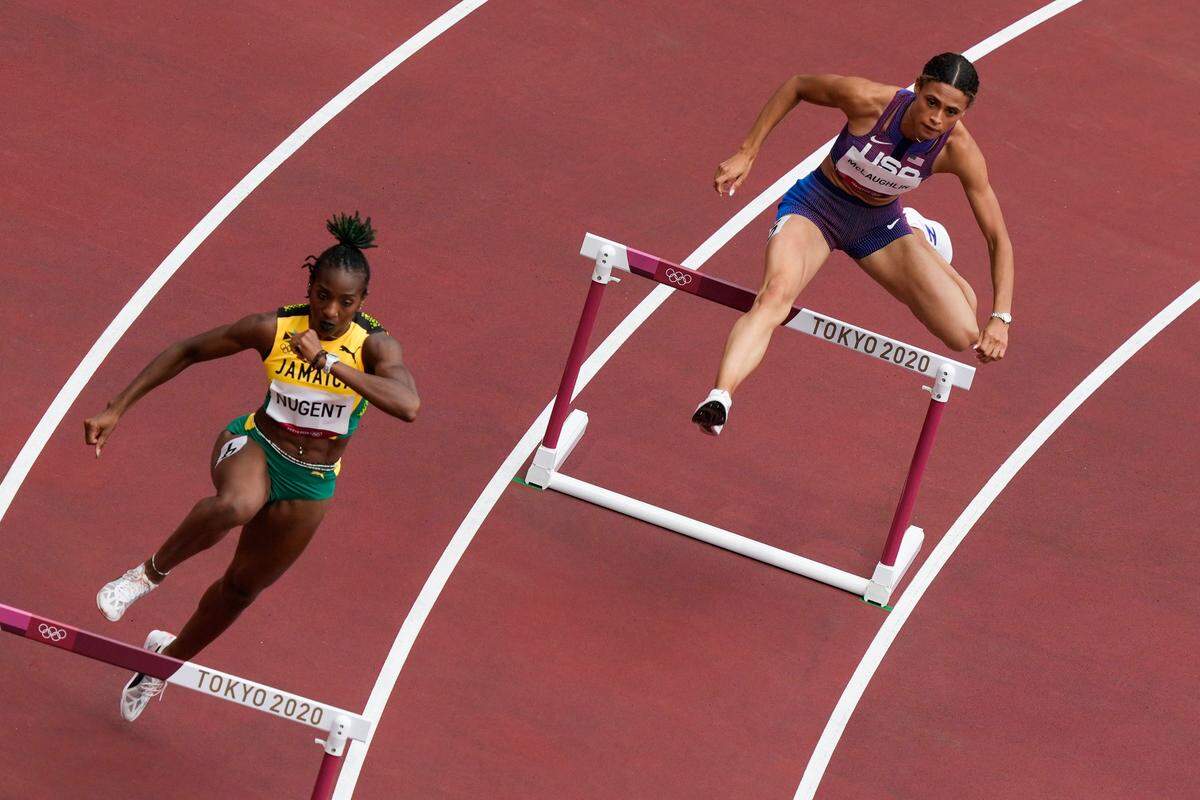 Sydney McLaughlin, right, won her heat in the women’s 400-meter hurdles on Saturday. She will try to give former Kentucky Wildcats stars a sweep of the Olympics women’s hurdles events when she runs in the finals Tuesday night.