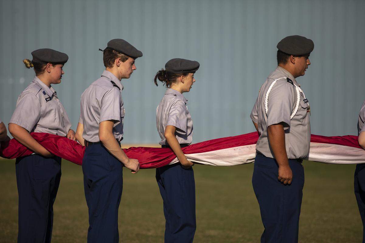 Members of the Breathitt High Army JROTC program practice carrying a giant U.S. flag onto the field before the start of Friday’s game.