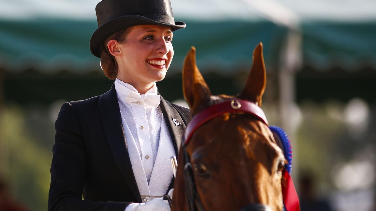 Hallie Ricci smiled during her victory lap after winning the Senior Saddle Seat Equitation Championship aboard Madeira's Fame at the Lexington Junior League Charity Horse Show at the Kentucky Horse Park on Saturday evening.