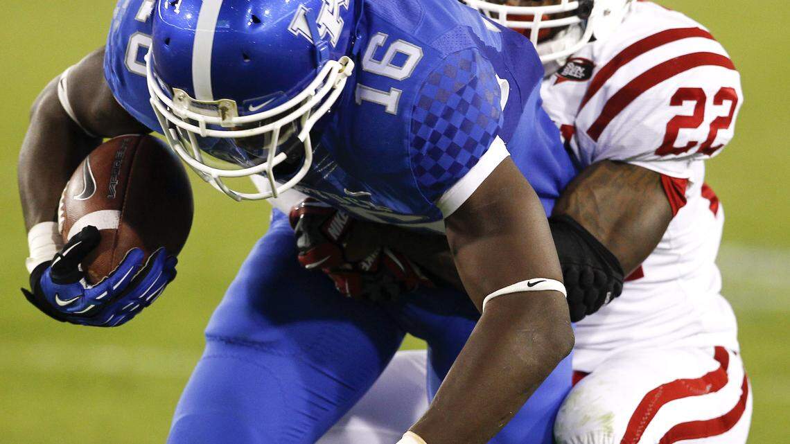 Kentucky Wildcats wide receiver La'Rod King (16) was dragged down by Western Kentucky Hilltoppers defensive back Tyree Robinson (22)  as UK lost to  Western Kentucky University  32-31  on Saturday September 15, 2012 in Lexington, Ky. Photo by Mark Cornelison | Staff