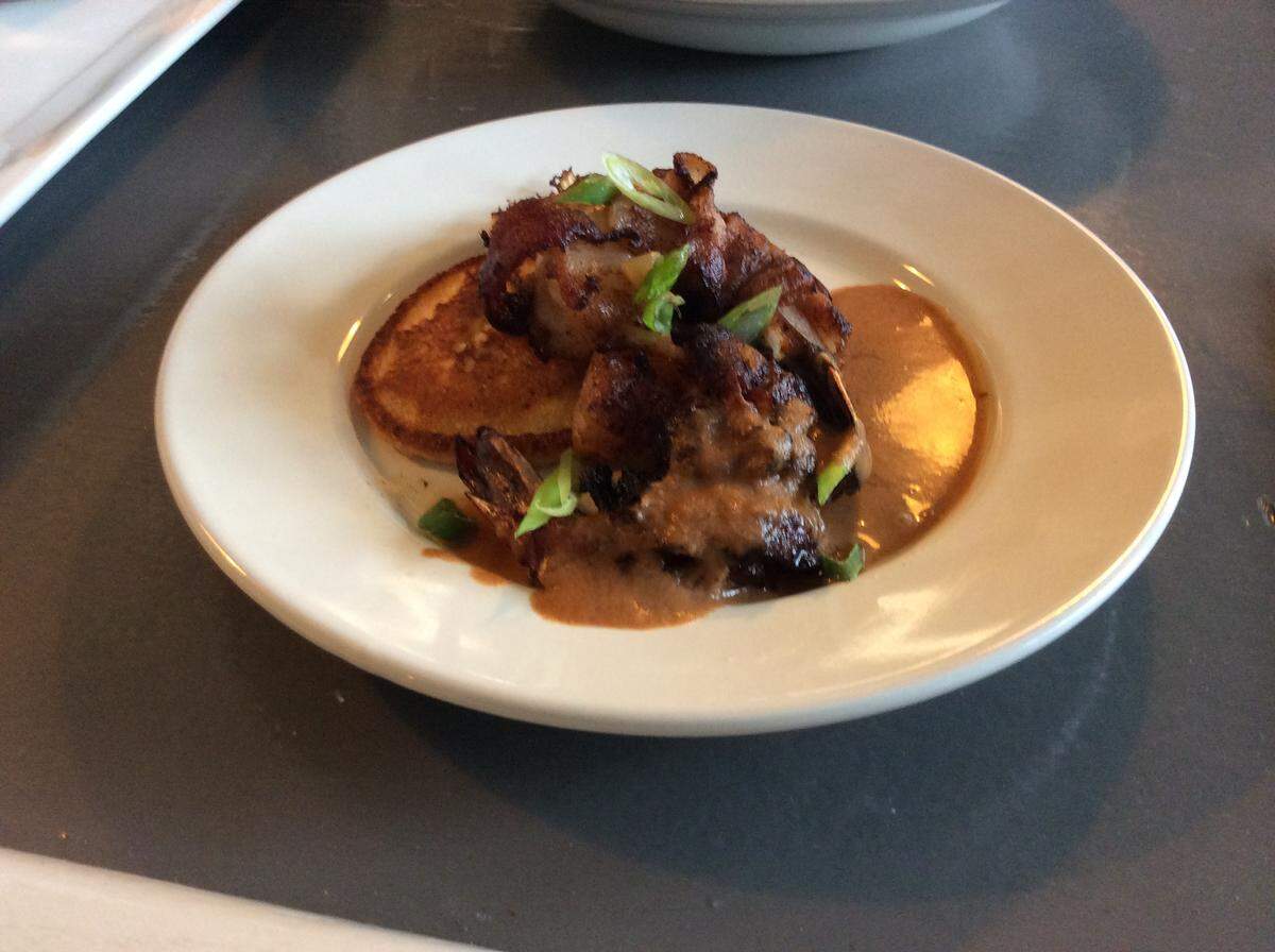 Roulay Restaurant and Bar is scheduled to open Feb. 17 with a limited menu, including Nola Style Bacon-Wrapped BBQ Shrimp, served on a sorghum corncakes with chow chow relish.