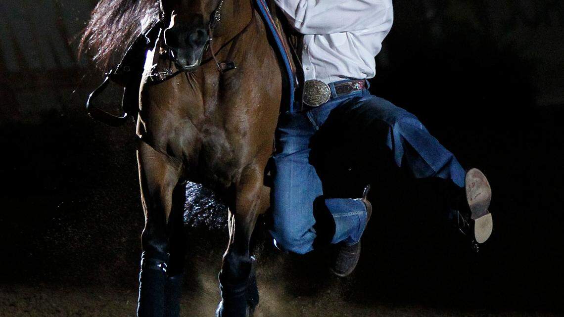 Trevor Dare hopped a long side his horse before re-mounting during freestyle reining exhibition  at  the Alltech Arena  on Thursday  September 30 , 2010 in Lexington, Ky. Photo by Mark Cornelison | Staff