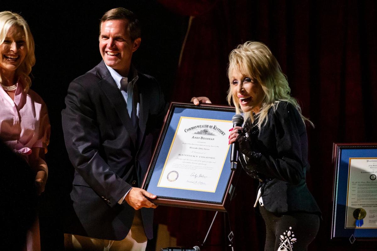 Dolly Parton reacts after being commissioned as a Kentucky Colonel by Gov. Andy Beshear at the Lyric Theater in Lexington, Ky., on Tuesday, August 27, 2024.