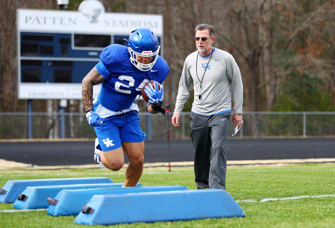 Offensive coordinator Eddie Gran put running back Chris Rodriguez through a drill. Gran was told upon his arrival five years ago that Kentucky was a basketball school but said, “It’s a football school as well.”