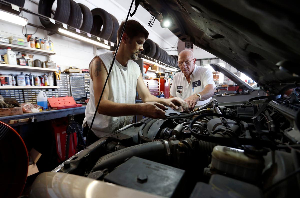 Benji Riddell, left, and owner Kermit Dixon replaced a water pump in the service bay at Dixon’s Service Center, 220 Southland Drive in Lexington. Dixon’s is believed to be the last full-service gas station in Lexington. In addition to gas, they do repairs and service on cars and lawn mowers.