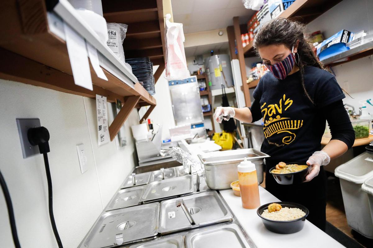 Reina Slaymaker, administrative asst. and server at Sav’s Restaurant and Gourmet Ice Cream prepares a takeout order Tuesday in the kitchen at at Sav’s on East Main Street.