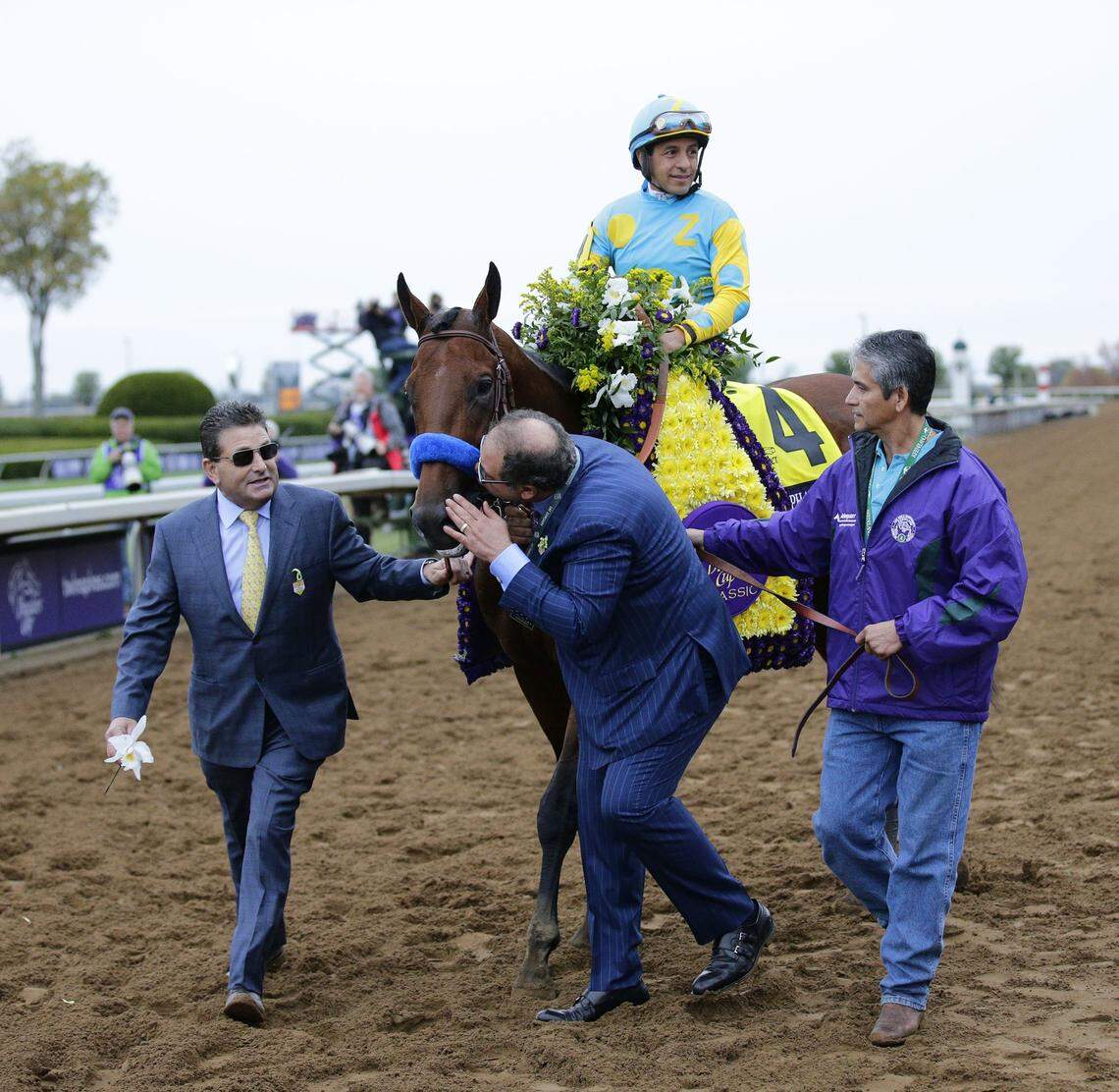 Ahmed Zayat gave American Pharoah a kiss Oct. 31, 2015 before leading him and jockey Victor Espinoza into the winners circle after winning the Breeders’ Cup Classic at Keeneland.