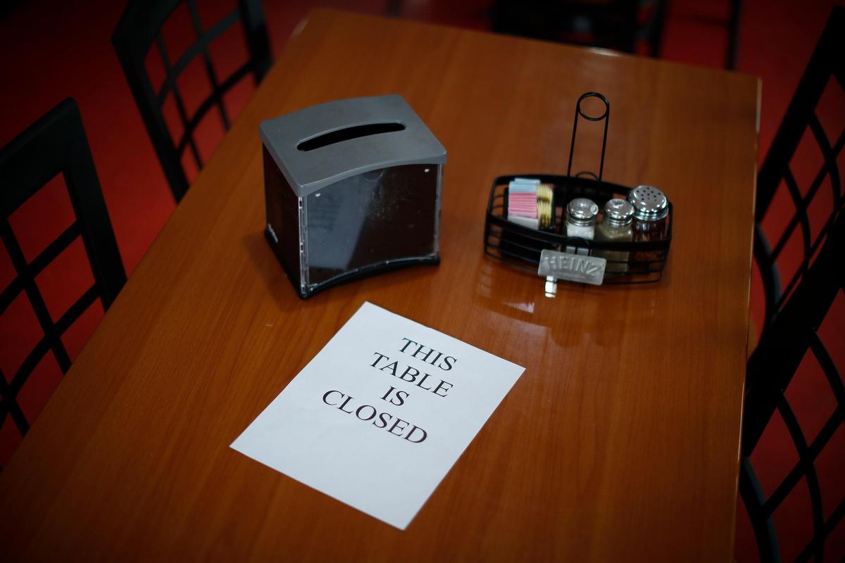 Every other table is closed to promote social distancing at The Pizza Spot in Jellico, Tenn., Tuesday, May 5, 2020.