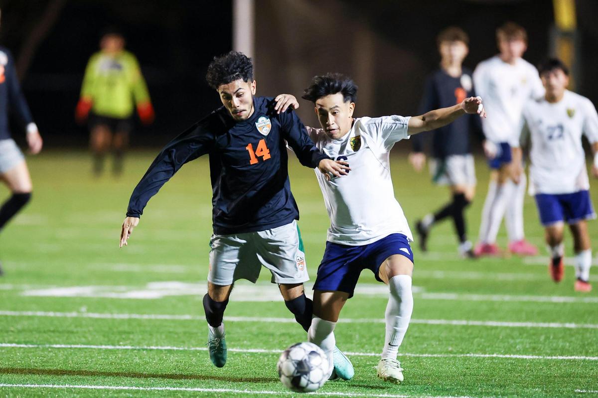 Frederick Douglass’ JP Figueroa (14) fights for control of the ball with Bryan Station’s Juan Mina (16) in their 42nd District soccer tournament semifinals game at Bryan Station on Tuesday.