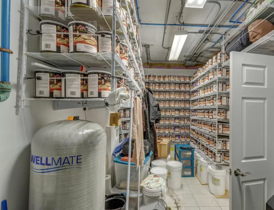 A storage room in the underground bunker is filled with large tubs of freeze-dried food and a water tank.