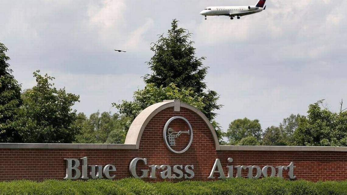A plane flies overhead at the Blue Grass Airport in Lexington, Ky.