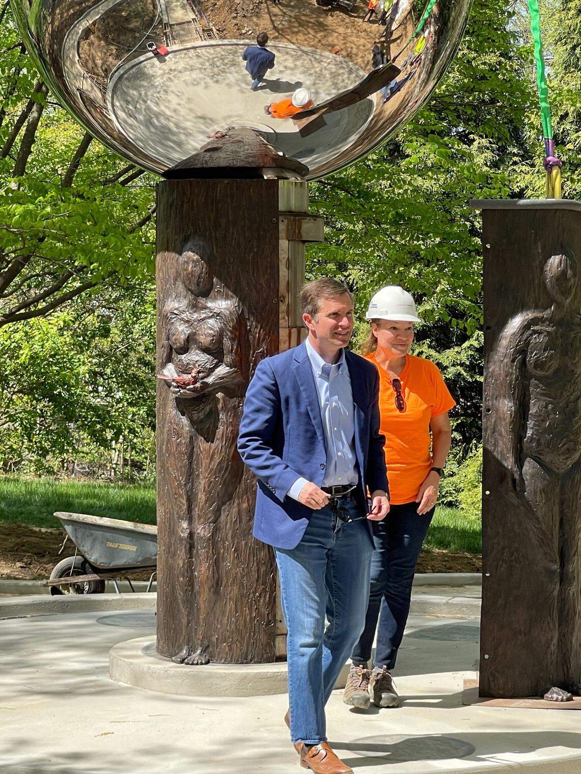 Gov. Andy Beshear and sculptor Amanda Matthews looked over the Kentucky COVID memorial earlier this year.
