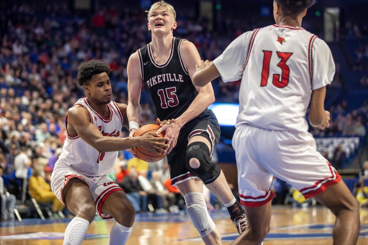 Jerone Morton of Clark County, left, tried to strip the ball from Pikeville’s Rylee Samons (15) with help from teammate Trent Edwards (13) during Friday’s game in Rupp Arena. “People know me for my offense, but they don’t know that I like to play really good defense and I like to guard the other team’s best player,” Morton said.