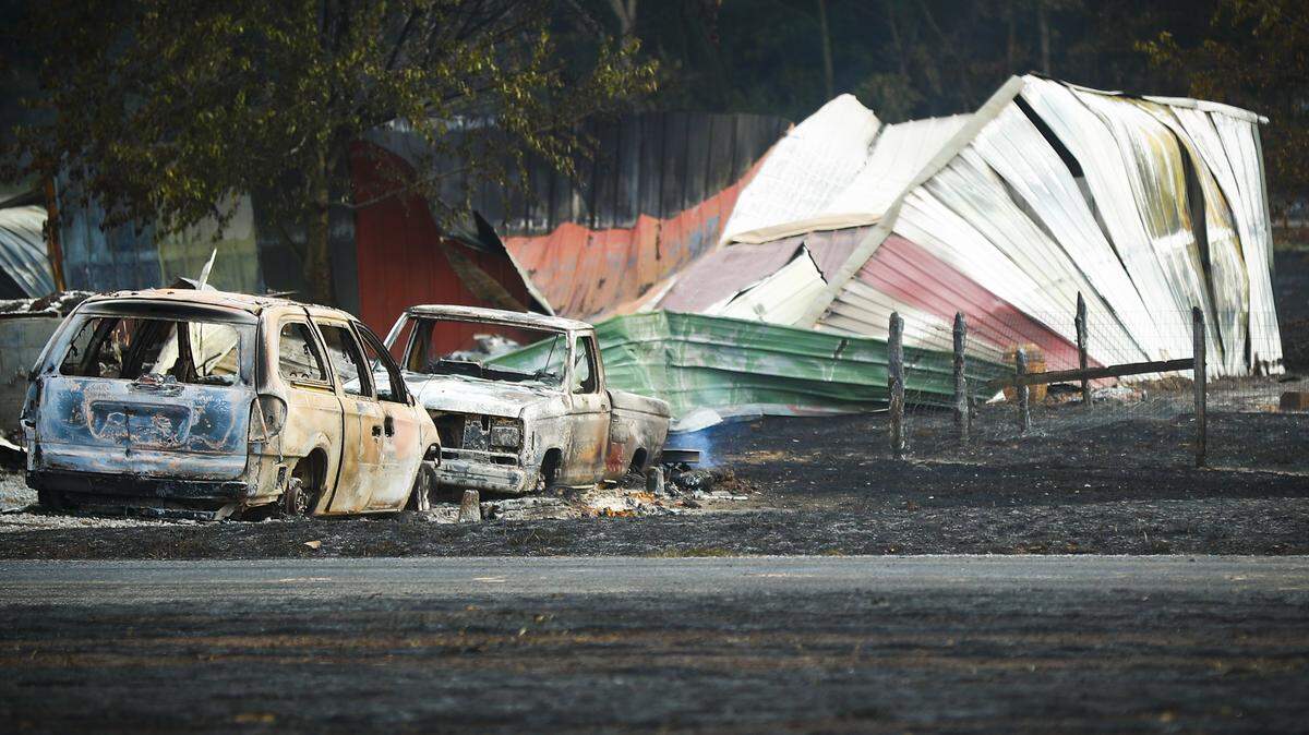 Burnt vehicles and destroyed buildings remained after a gas pipeline explosion just outside of Juction City Thursday.