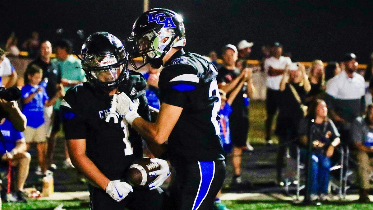 Lexington Christian's Tyler King (1), left, celebrates with Lexington Christian's Dawson Farmer (23) after King caught the winning touchdown pass during LCA's 28-21 win over Lexington Catholic during a high school football game, Friday, Sept. 19, 2025 at Lexington Christian Academy in Lexington, Ky.