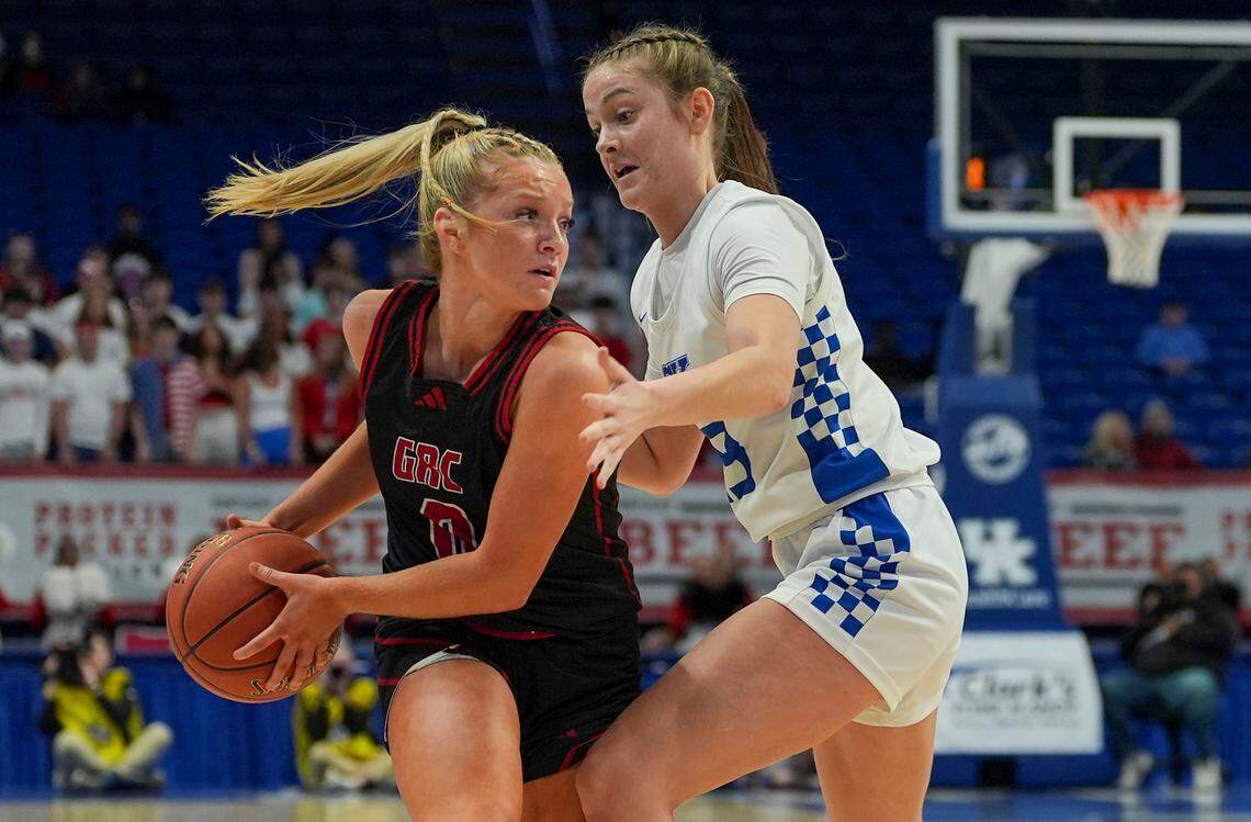 George Rogers Clark’s Kennedy Stamper shields the ball from Simon Kenton’s Anna Kelch during Clark’s Pump-N-Shop Girls’ Basketball Sweet 16 semifinals at Rupp Arena on Saturday.
