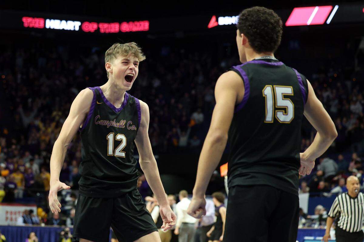 Campbell County’s Broc Sorgenfrei (12) and Garyn Jackson (15) celebrate after knocking off Newport in the first round of the Boys’ Sweet 16 in Rupp Arena on Thursday night.