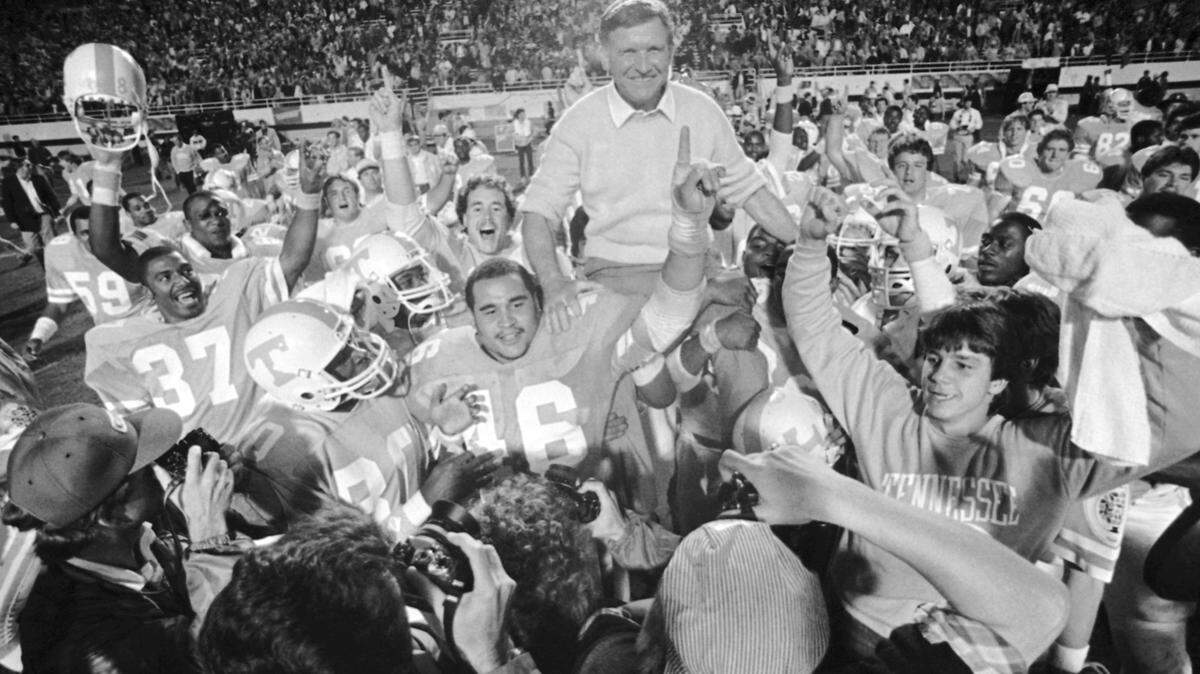 Tennessee players carried coach Johnny Majors off the field in celebration after the Volunteers beat Maryland in the 1983 Citrus Bowl in Orlando, Fla. UT announced Wednesday that Majors has died at age 85.