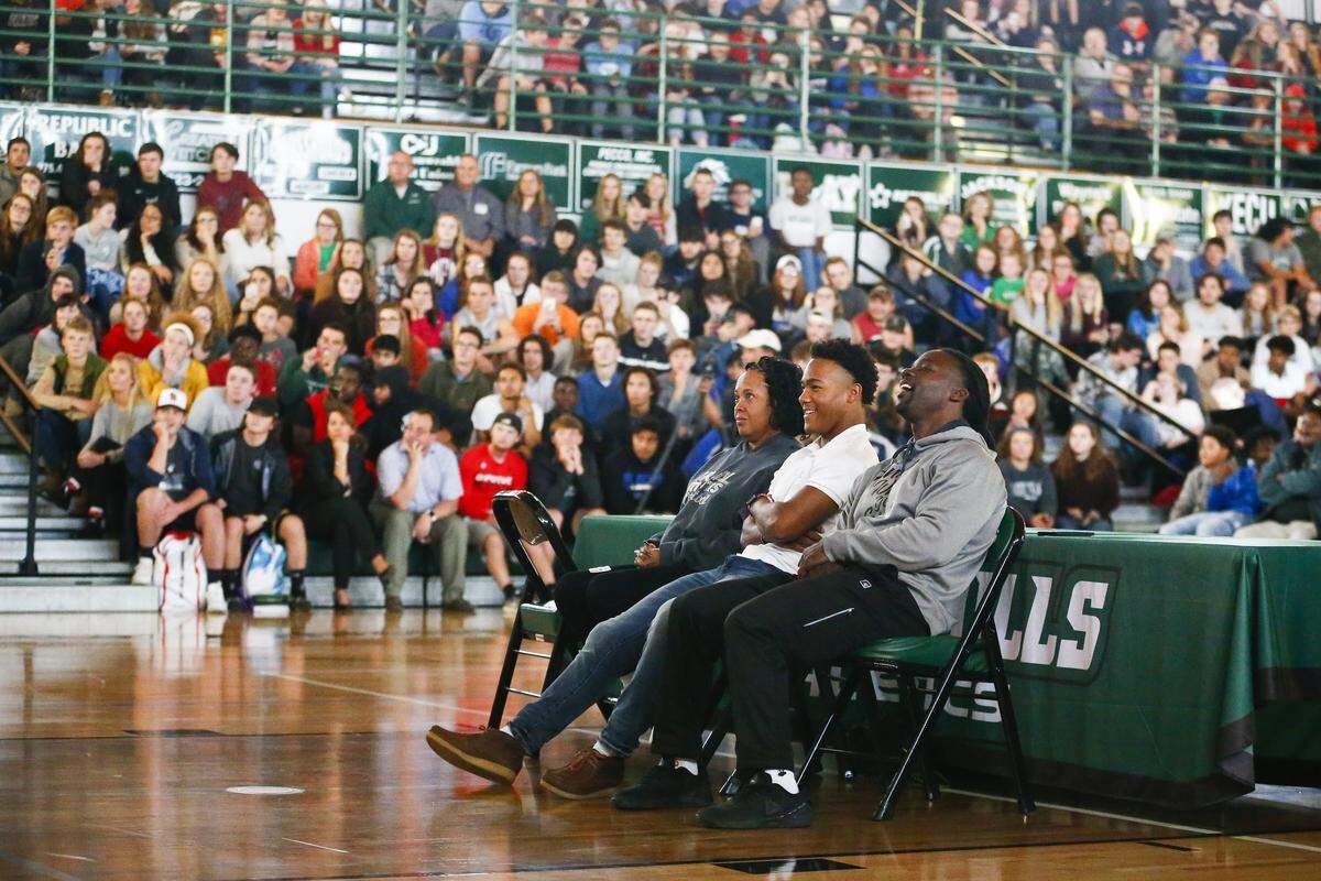 Western Hills four-star running back Wandale Robinson watched a highlight video with his parents, Vicki Davis and Dale Robinson before committing to the University of Kentucky Thursday at Western Hills High School in Frankfort. 