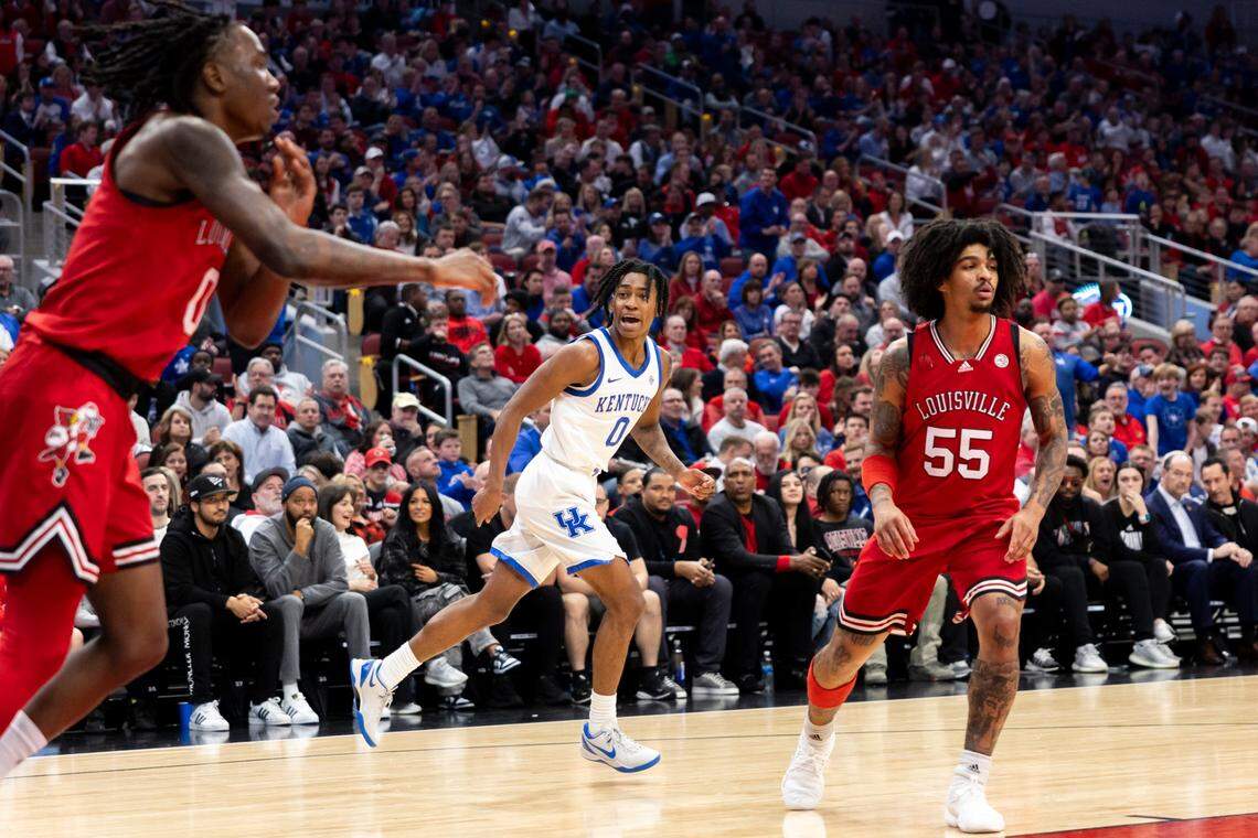 Kentucky guard Rob Dillingham (0) talks to Louisville guard Mike James (0) after scoring against him in the first half Thursday at the KFC Yum Center.