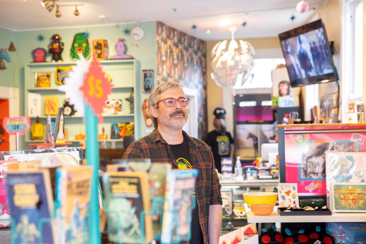 Dustin Benzig, Earth to Kentucky co-owner, poses for a portrait in the shop in Covington, Ky., on Thursday, April 21, 2022.