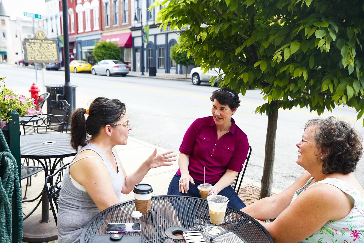 Kentucky 6th Congressional District candidate Amy McGrath, center, spoke with Sherry Thompson, left, and  Paige Slover, both of Versailles, outside of the Amsden Coffee Club while campaigning Monday in downtown Versailles.