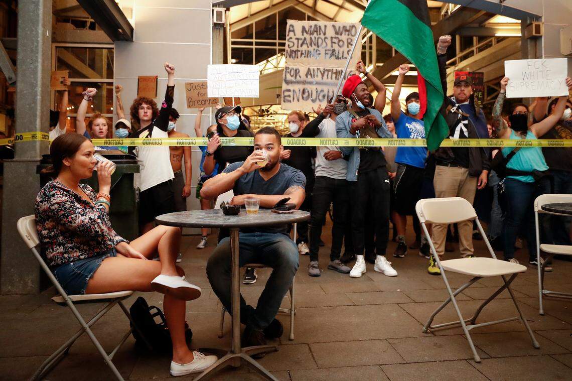 Demonstrators confront a couple drinking in the Firth Third Pavilion during the eighth night of protests in downtown Lexington, Ky., Friday, June 5, 2020. The protests come amid a nationwide outcry over the deaths of George Floyd in Minneapolis and Breonna Taylor in Louisville.