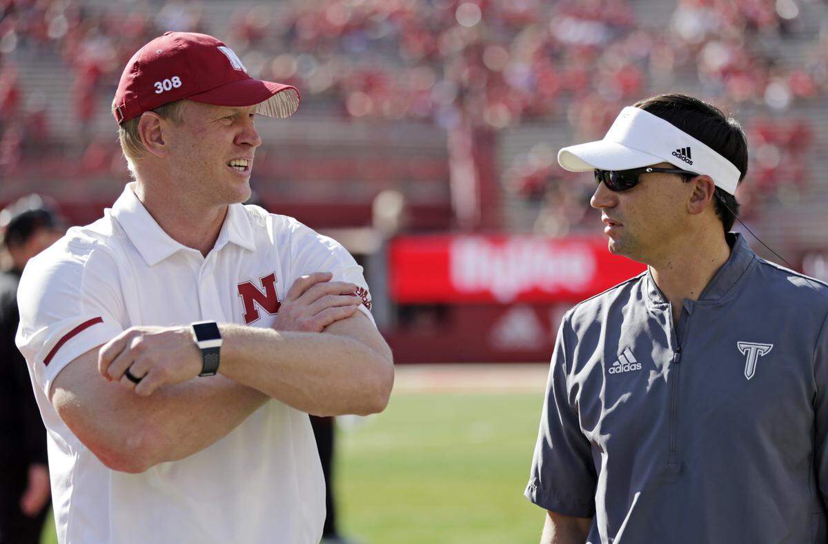 Troy head coach Neal Brown, right, chatted with Nebraska first-year coach Scott Frost before Saturday’s game in Lincoln, Neb.