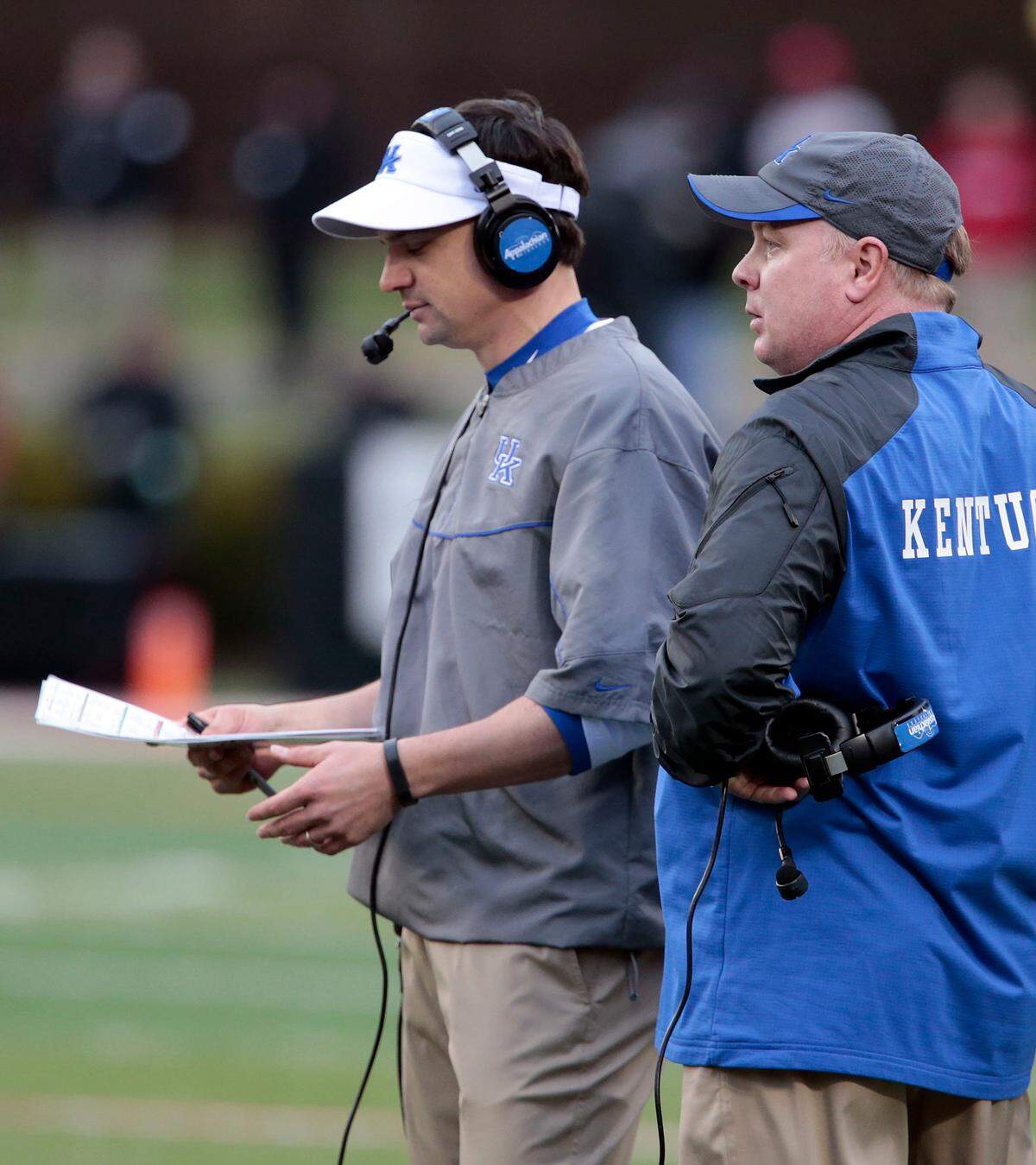 Neal Brown, left, was the offensive coordinator for Mark Stoops during the 2013 and 2014 seasons.