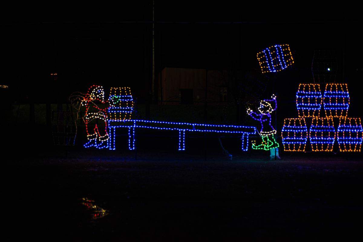 Santa and an elf roll and stack barrels of bourbon at the Holiday Lights at the Distillery at Buffalo Trace in Frankfort.