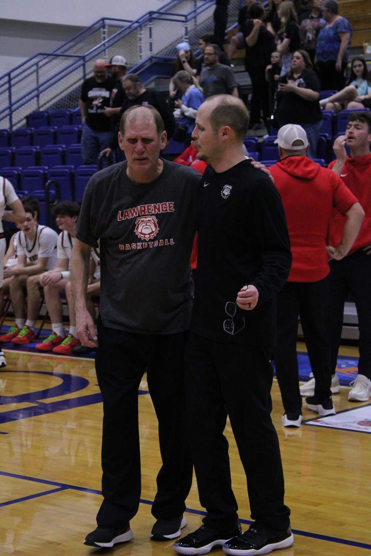 Lawrence County boys basketball coach Chandler Thompson, right, celebrated winning the 15th Region Tournament with his father, and assistant coach Mark, left.