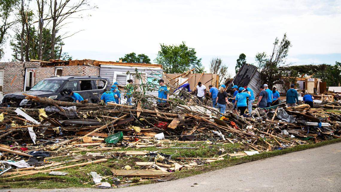 Members of Advent Health in Manchester form a clean-up crew, assisting with the removal of debris in the Sunshine Hills subdivision following Saturday’s deadly tornado storm in Laurel County on May 17, 2025, in London, Ky.