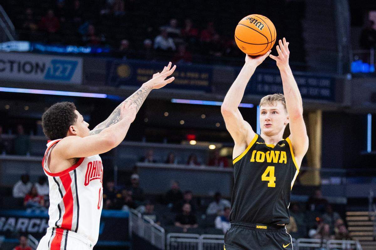 Mar 12, 2025; Indianapolis, IN, USA; Iowa Hawkeyes guard Josh Dix (4) shoots the ball while Ohio State Buckeyes guard John Mobley Jr. (0) defends in the first half  at Gainbridge Fieldhouse. Mandatory Credit: Trevor Ruszkowski-Imagn Images