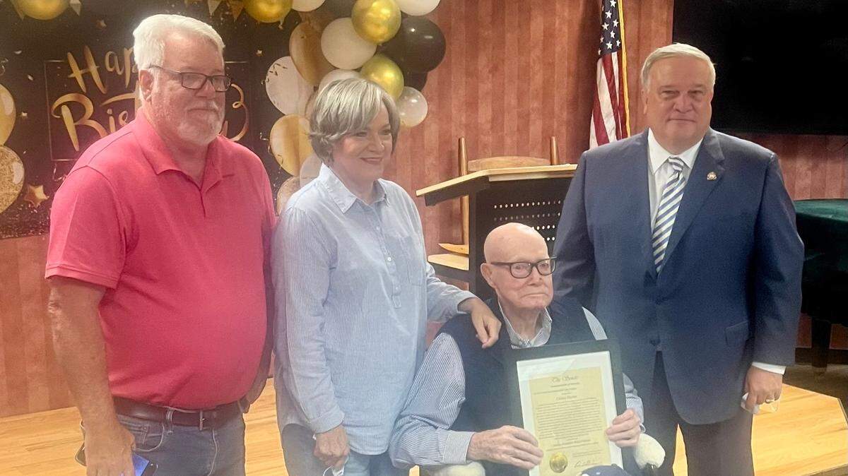 Vincent Hacker, left, and Fatima Hacker Brown celebrated with their father, Oakley Hacker, and Kentucky Senate President Robert Stivers, right, on Oakley Hacker’s 107th birthday.
