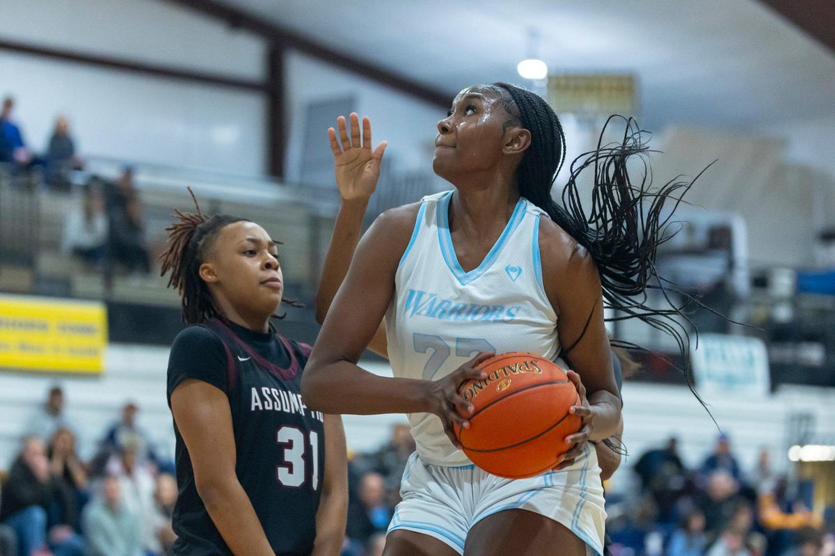 Danville Christian’s Grace Mbugua, right, looks to shoot the ball as Assumption’s Ashlinn James (31) defends during Thursday’s game.