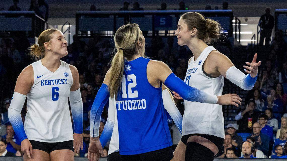 Kentucky outside hitter Brooklyn Deleye, right, celebrates an ace with libero/defensive specialist Molly Tuozzo (12) and setter Kassie O'Brien (6) during UK’s 3-0 win against Arkansas on Sunday.