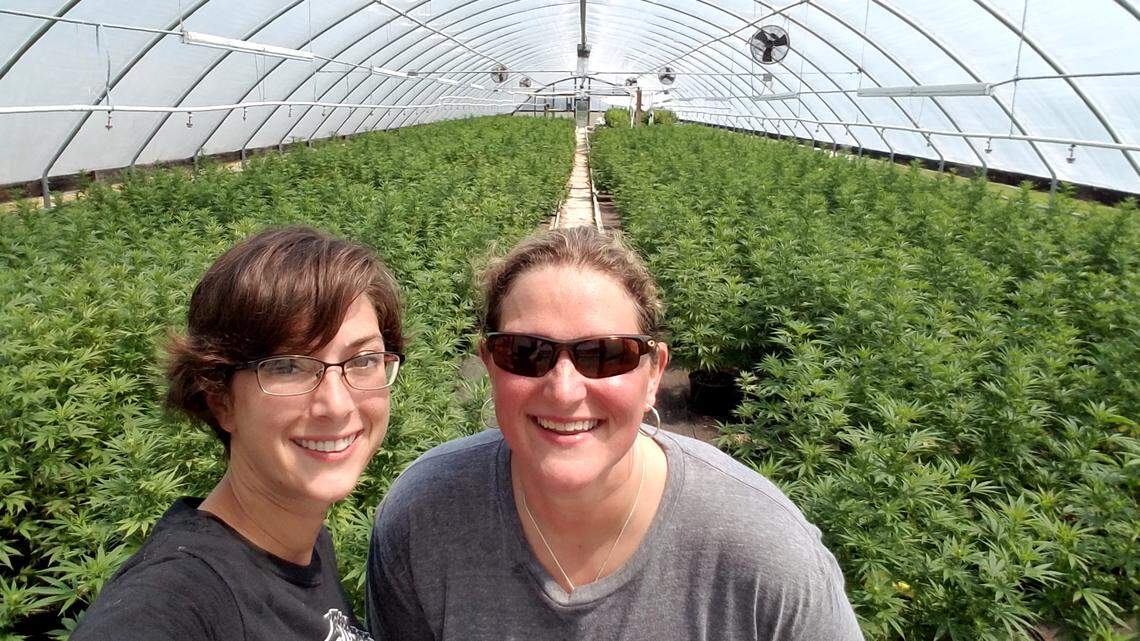 Katie Moyer of Kentucky Hemp Works, left, with Tourism Commissioner Kristen Branscum in a greenhouse full of hemp plants during the 2017 solar eclipse.