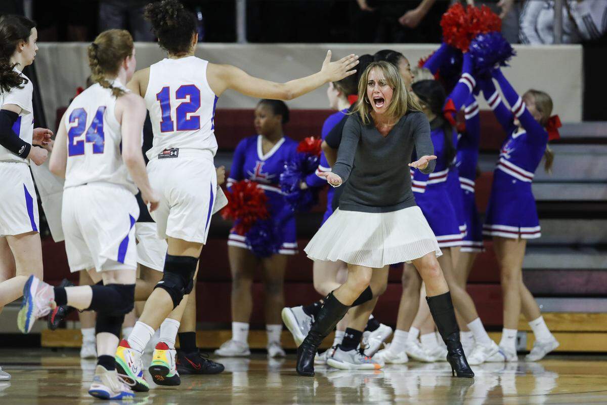 Lafayette coach Allison Tate Denton celebrates a score ahead of halftime against Henry Clay during the 11th Region Tournament semifinals at Eastern Kentucky University’s Alumni Coliseum in Richmond on March 3, 2022.