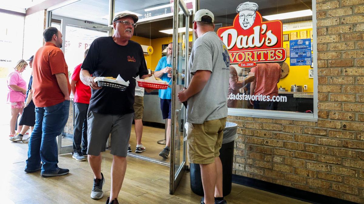 James “Dad” Caudill, owner of Dad’s Favorites Deli, delivers lunch, Thursday, June 26, 2025, at the sandwich shop in Lexington, Ky. The deli opened in the 2010 in the Garden Springs Shopping Center.