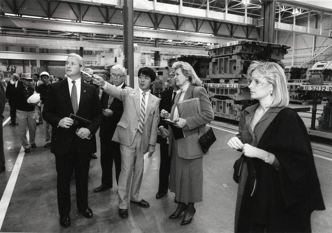 The new Toyota Motor Manufacturing plant in Georgetown holds a dedication ceremony on October 6, 1988. Participants are taking a tour of the plant following the ceremony. From left to right, Georgetown Mayor Tom Prather, Kido Toshiyuki, interpreter (pointing), and former Kentucky Governor Martha Layne Collins. Far right is Gov. Collins' daughter, Marla Collins. Charles Bertram | Staff