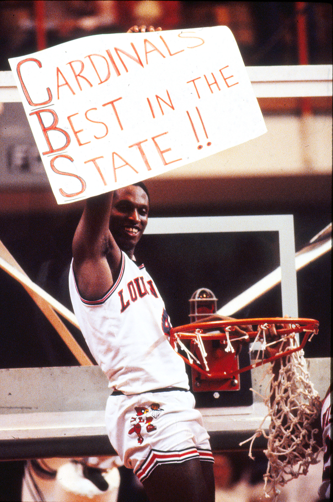 Louisville’s Lancaster Gordon celebrated March 26, 1983 after the Cardinals beat rival Kentucky, 80-68 in overtime, during the NCAA Mideast Regional Finals in Knoxville. It was an emotional, much anticipated battle before a capacity crowd of 12,489 at the University of Tennessee’s Stokely Athletics Center. The two schools had not met on the hardwood since the 1959 NCAA Tournament and not in the regular season since 1922. Kentucky was following a policy set by Adolph Rupp; they refused to play other in-state foes regardless of the strength of their teams. By 1983, U of L coach Denny Crum had already taken Louisville to four Final Fours, won the 1980 national title and clearly built a program that, on the floor, was at the least UK’s equal if not its superior. Yet the Cats wouldn’t play the Cards, but on this day, they had to to advance to their ninth Final Four. U of L missed 16 of its first 20 shots but turned up their press in the second half. Within two minutes, an 11-point second-half UK lead was cut to one. Kentucky’s Jim Master made a game-tying shot to force overtime but the Cards scored the first 14 points of the extra period. Gordon led all scorers with 24 and was named Most Valuable Player of the Regional. Facing pressure from fans and even the state legislature, the teams renewed their regular season match-up the following season and have faced each other every year since.