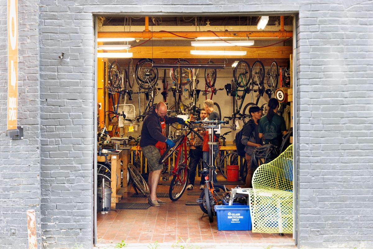 Volunteer mechanic Guy Hamilton-Smith works on a customer’s bicycle on Sunday, May 22, 2022, at Broke Spoke Community Bike Shop in Lexington, Kentucky.