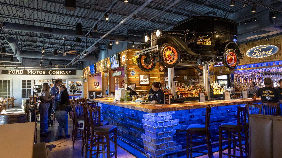 Part of the nostalgic automotive memorabilia inside Ford’s Garage includes a Ford Model A replica suspended above the bar, photographed Tuesday, Nov. 4, 2025, in Lexington, Ky. The car’s wheels move and horn honks. There are 26 beers on tap at the Lexington location.